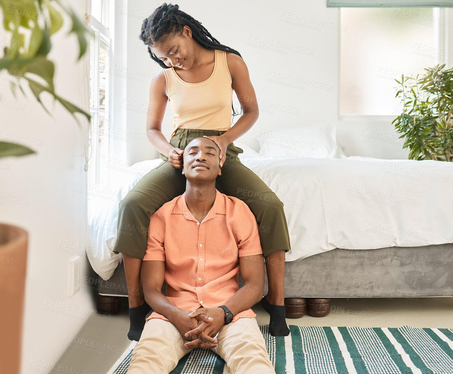 Buy stock photo Love, head massage or black couple in home to relax, smile or enjoy anniversary together for peace or trust. Romantic, woman or African man in bedroom for bonding with care, support or special moment