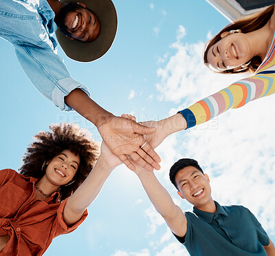 Buy stock photo Friends, hands and portrait in outdoor stack, huddle and low angle for teamwork on blue sky. Happy people, social diversity and pile for support or reunion, together and youth culture for motivation