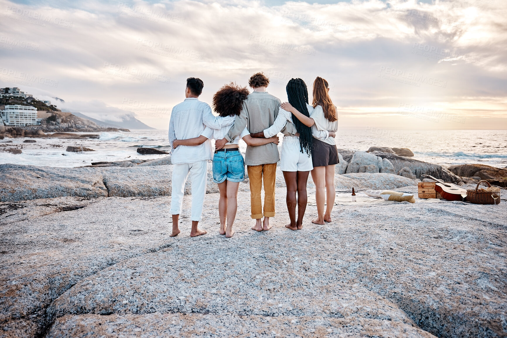 Buy stock photo Rock, back and friends on beach for hug, embrace and bonding together on vacation in California. People, men and women with freedom for hangout, chilling and adventure holiday in ocean outdoor