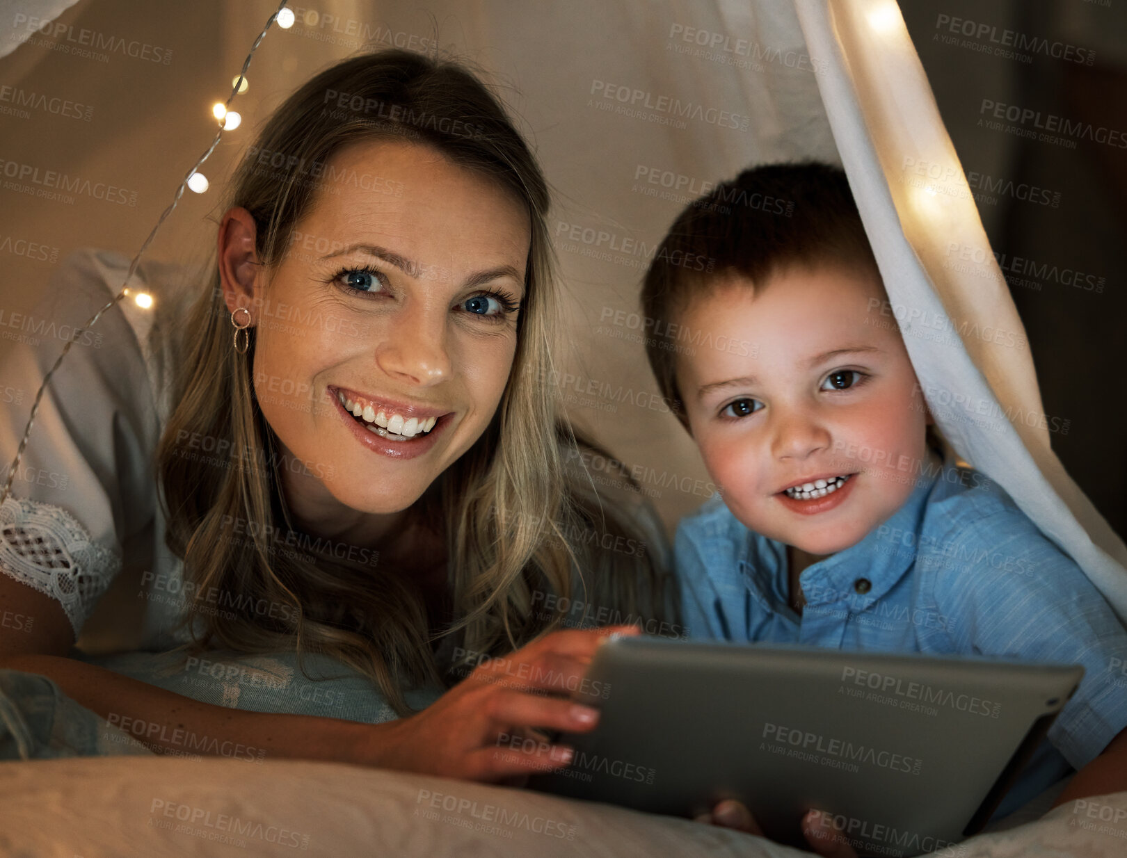 Buy stock photo Mother, boy and tablet at night in portrait, online and app for playing games or website for series. Mommy, son and blanket for fort or watching movie in bedroom, streaming and rest together in home