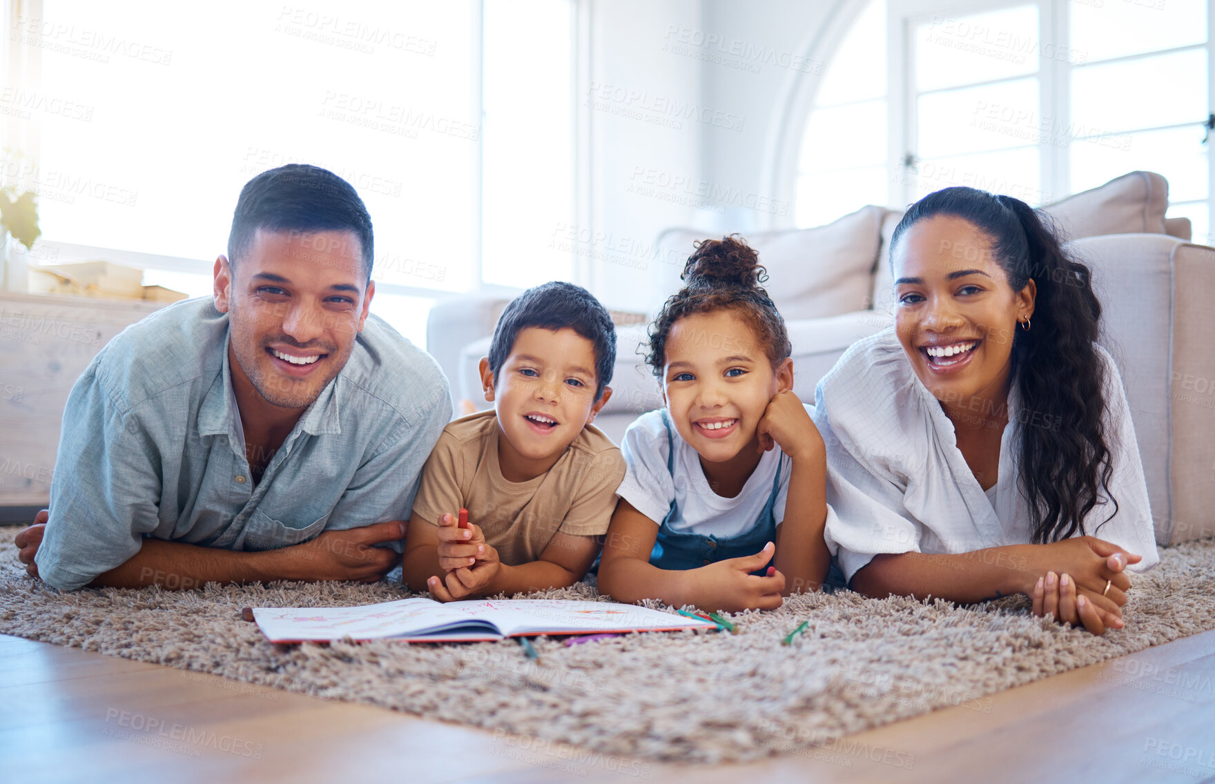 Buy stock photo Happy family, portrait and lying with book on floor for education, learning or activity together at home. Mother, father and children or siblings with smile, drawing or creativity on carpet at house