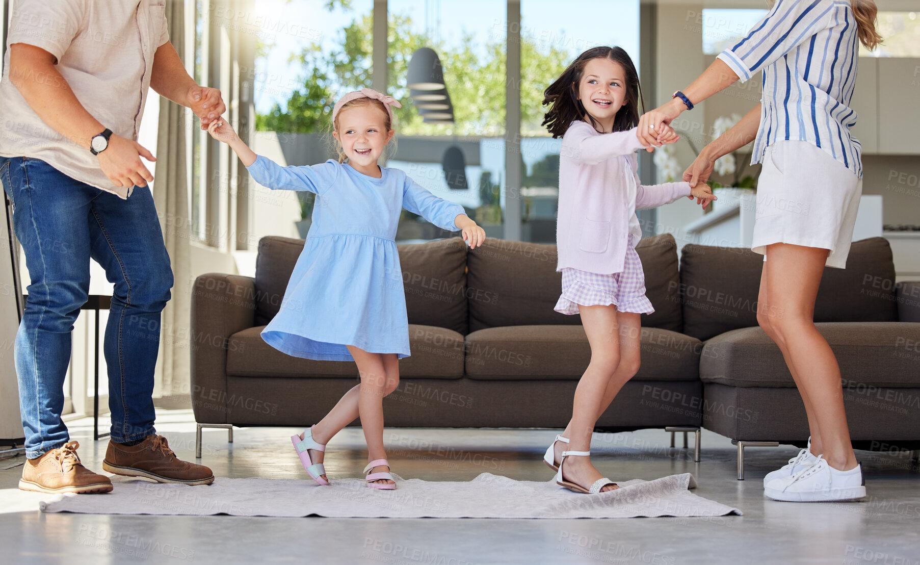 Buy stock photo Family, dancing and holding hands in home for energy, fun and support for movement in living room. Parents, children and happiness for performance or teaching in apartment, helping and wellness