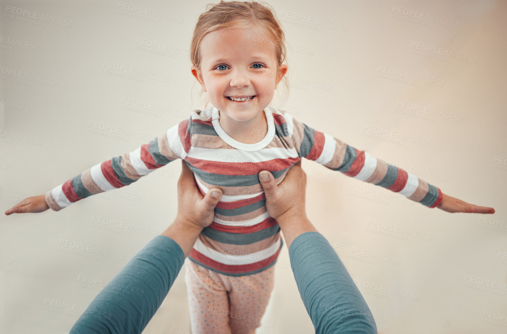 Buy stock photo Airplane game, hands and portrait of child on bed for support, balance and care or love in home. Happy, kid or girl and parent for fantasy in apartment with wellness or together for trust and play