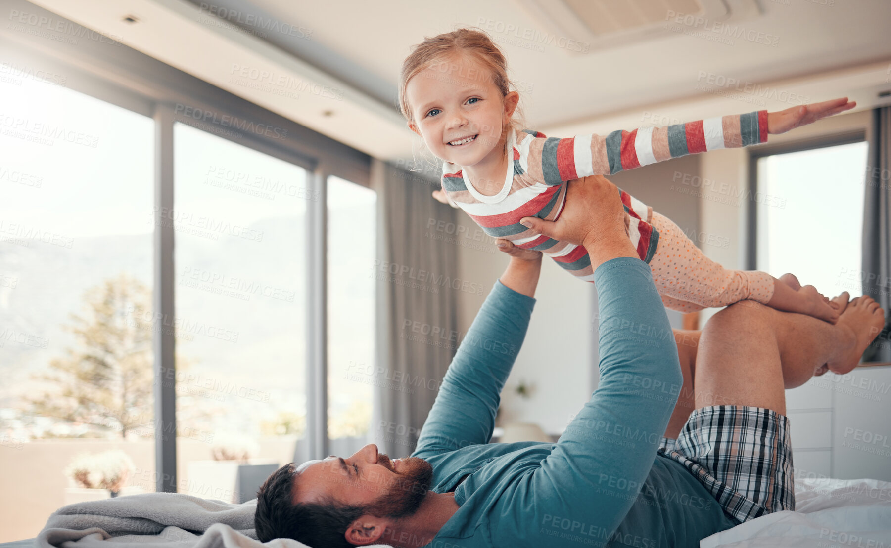 Buy stock photo Airplane game, man and portrait of child on bed for support, balance and care or love in home. Happy, kid or girl and dad or fantasy in apartment or house for wellness, trust and together for playing