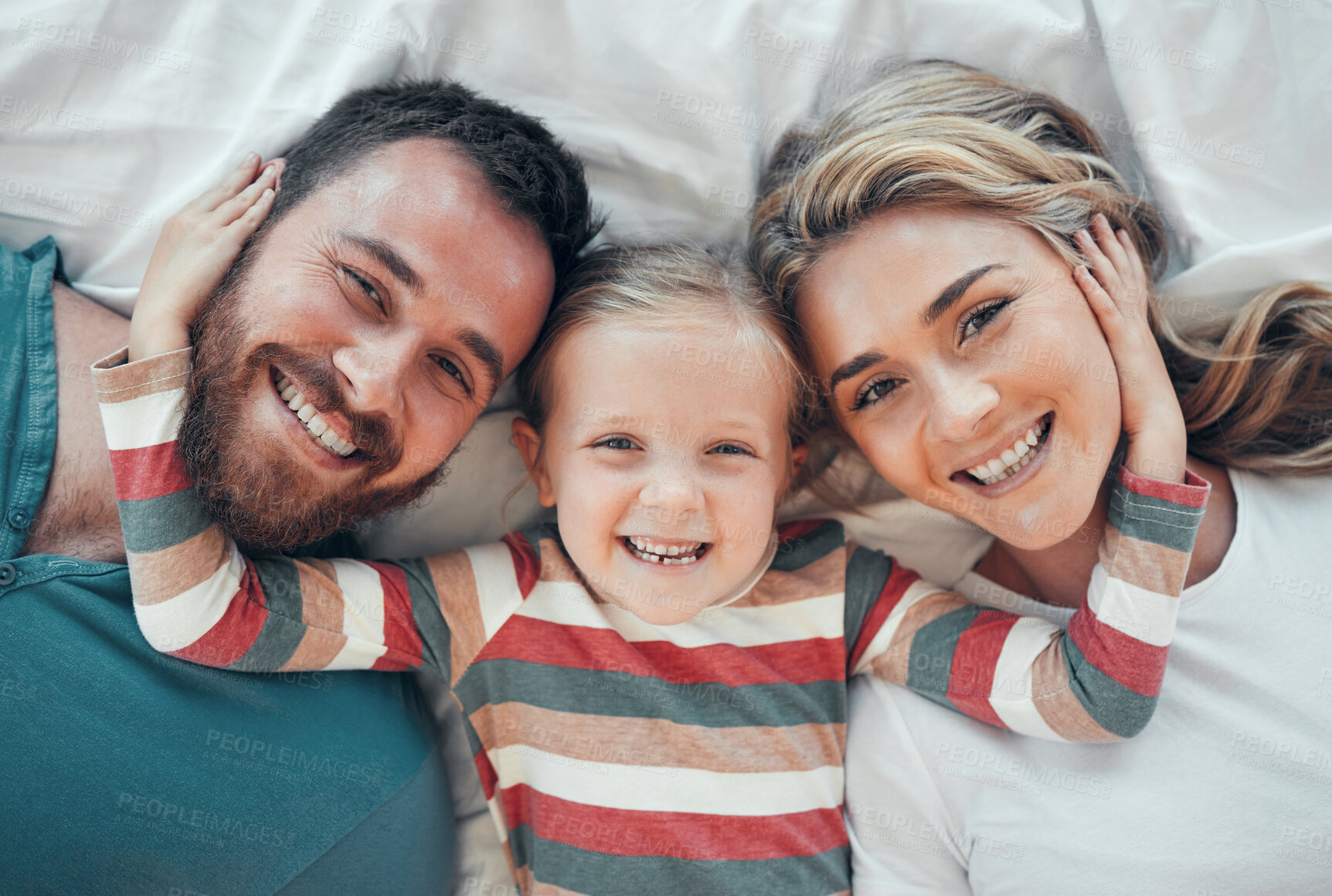 Buy stock photo Top view, portrait and happy family on bed for love, support and relax together in home. Mom, dad and parents with kid or excited girl for house, wellness and protection in morning or apartment