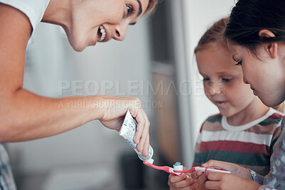 Buy stock photo Mother, kids and toothpaste on toothbrush for dental hygiene with learning, helping or oral health. Routine, siblings or parent with teaching, brushing teeth or cleaning mouth for gum disease in home