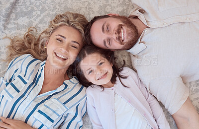 Buy stock photo Happy, portrait and family in above on floor to relax for love, bonding and care with connection on weekend. Smile, parents and child rest with affection, security and trust together at house