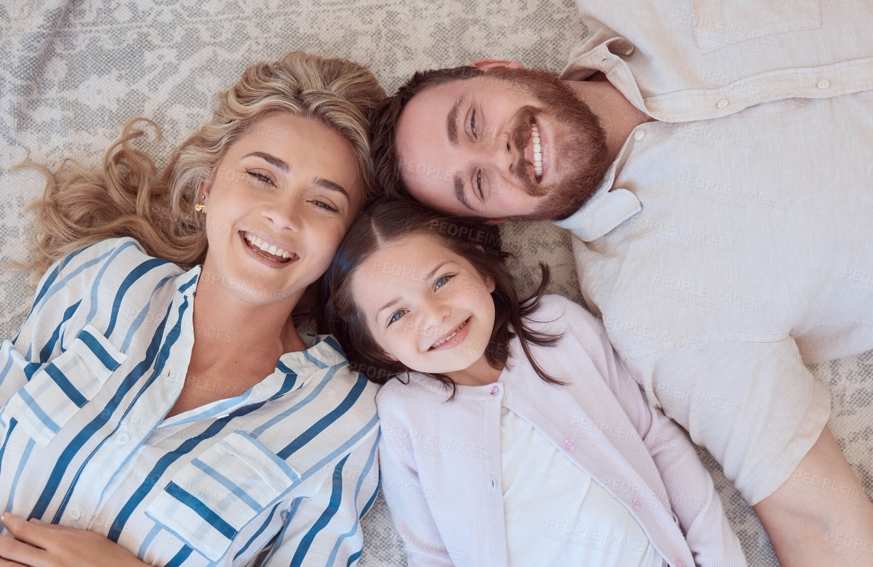 Buy stock photo Happy, portrait and family in above on floor to relax for love, bonding and care with connection on weekend. Smile, parents and child rest with affection, security and trust together at house