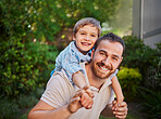 Happy caucasian father and son having fun and playing together outside. Carefree man carrying excited son for a piggyback ride while bonding in the garden. Single dad enjoying quality time with kid