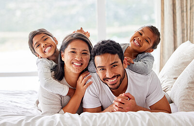 Buy stock photo Family, portrait and hug on bed together, love and bonding for security in relationship. Parents, children and embrace kids or support on weekend, comfortable and happiness in bedroom of care in home