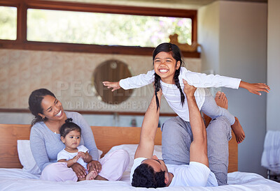 Buy stock photo Family, flying game and happy in bedroom, morning fun and bonding together in home for support. Father, daughter and balance for airplane lifting on bed, laughing and fantasy playing on weekend