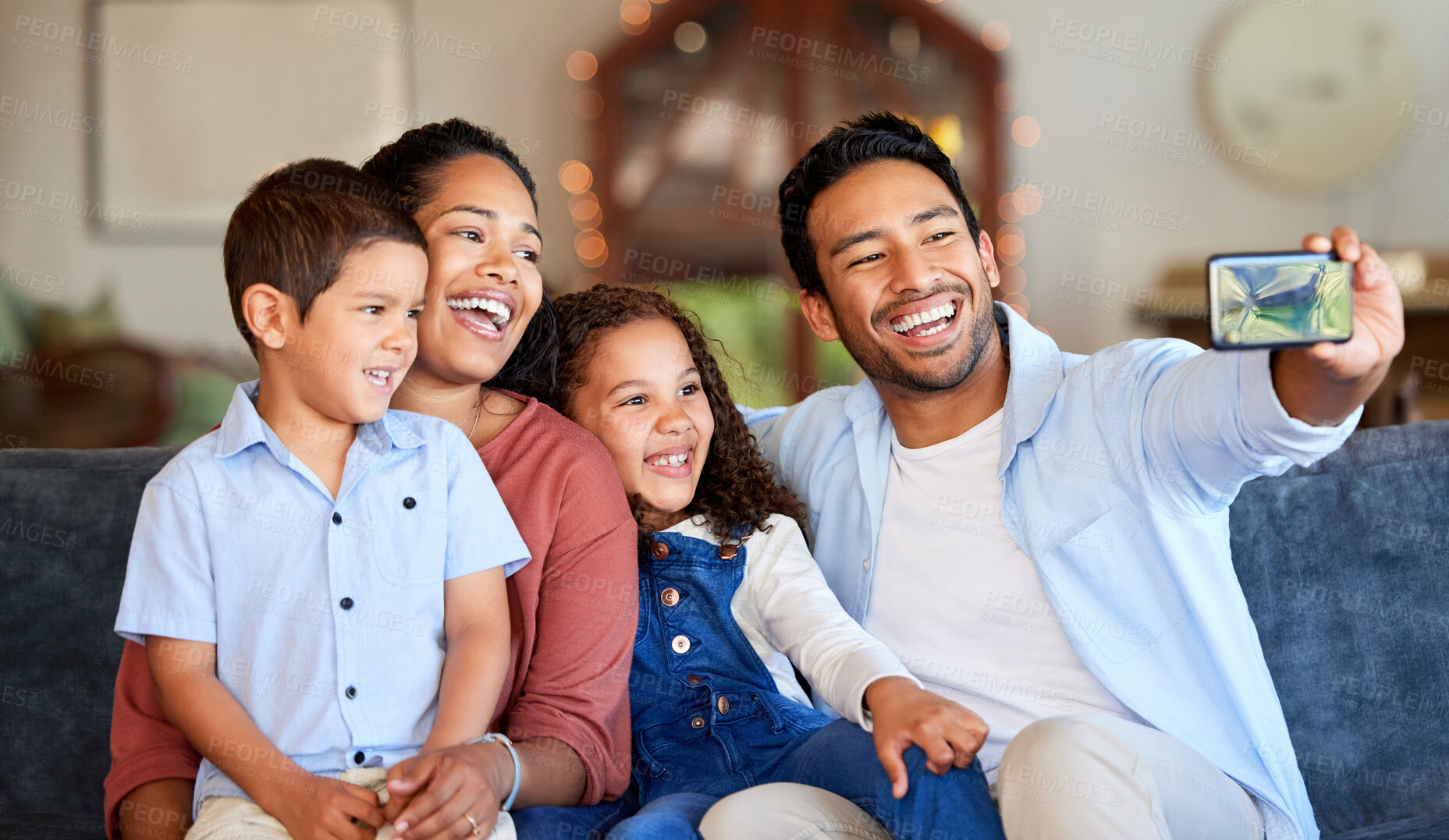 Buy stock photo Selfie, man and family with happiness on sofa for photography, memory or social media post. Love, children and hispanic parents with smile for profile picture, care or bonding together in home