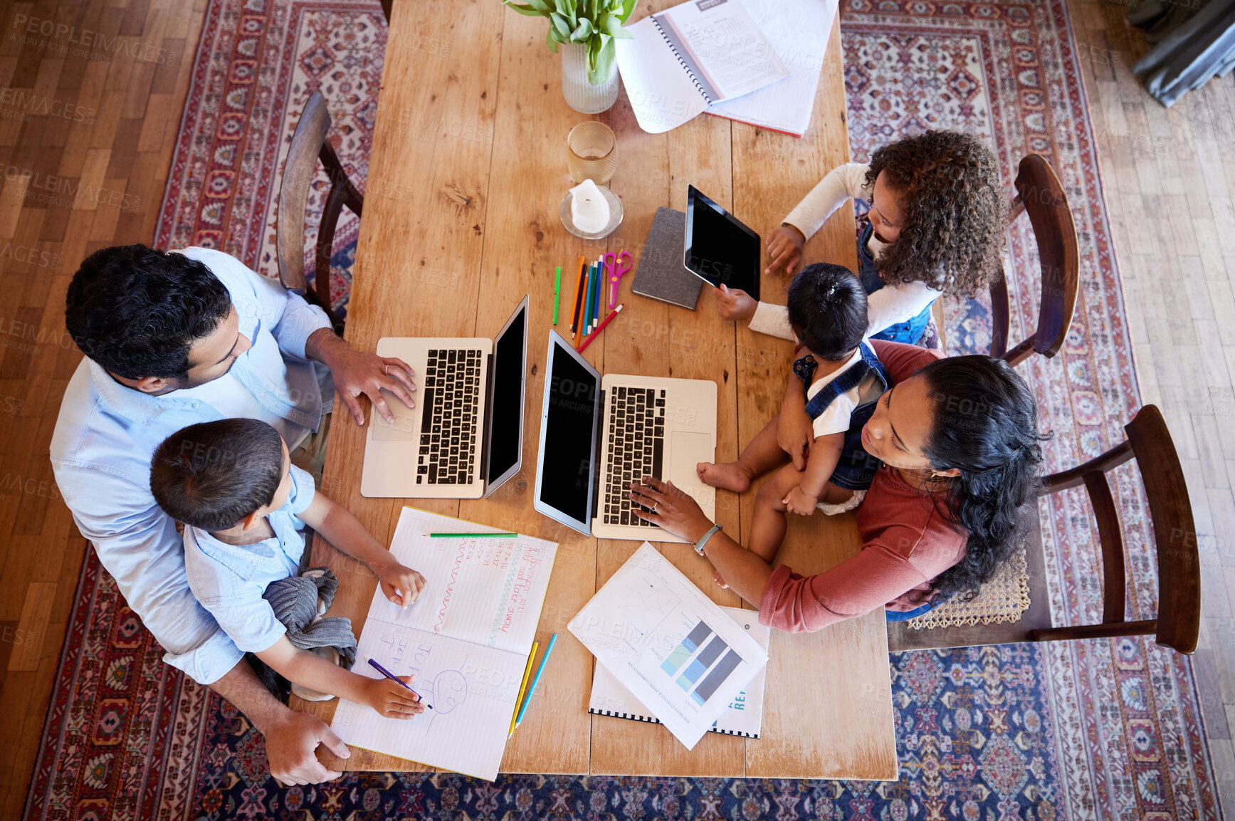 Buy stock photo Above, laptop and family in home for e learning, streaming and online or videos for education. Children, parents and technology at table in apartment for teaching, studying and together in morning