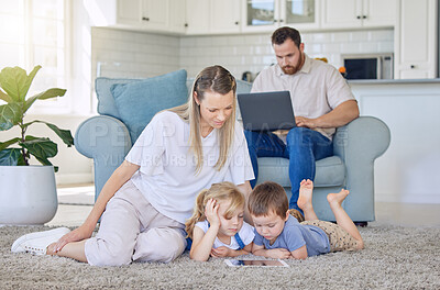 Buy stock photo Mom, parents and kids with tablet on floor for playing, fun and home with digital education for child development. Family, people and smile in living room with online games or cartoon for learning