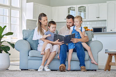 Buy stock photo Parents, kids and home with storytelling on sofa for fantasy, bonding and care with education. Family, people and support  with learning on book reading for knowledge, information and child growth