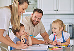 Caucasian parents helping children with homework. Happy siblings doing school work. Mother helping her son with homework.Brother and sister drawing with parents. Family doing homework in the kitchen 