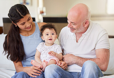 Buy stock photo Couple, parents and baby with love on sofa for bonding, adoption and child development in living room. Happy family, infant and foster kid on couch in home for safety, parenting or relax with support