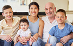 Happy interracial family bonding and relaxing together at home. Brothers and their sister sitting with their caucasian father and mixed race mother. Man and woman spending time with their children