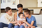 Multiracial family at home. Mother with her adoptive sons. Young mixed race mother relaxing with her children. Diverse blended family relaxing together at home. Boys spending time with their sister
