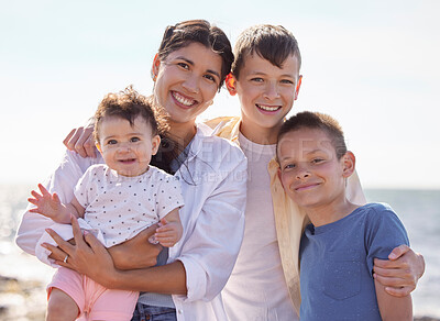 Buy stock photo Family, portrait and happy at beach for bonding, holiday and travel outdoor together during summer. Woman, face and children adoption at ocean for love, vacation and trip to Spain with fun and smile