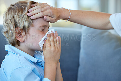 Buy stock photo Blowing nose, child and hand of mother for fever with flu, cold or allergy on sofa at home. Sick, medical emergency and mom feel head of kid for high temperature with illness in living room at house.