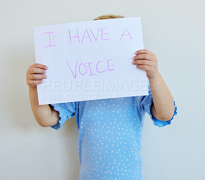 Buy stock photo Child, poster and sign for freedom of speech in studio with banner or care for human rights. Kid, protest and voice or peace for change and rally for bullying or domestic violence by white background