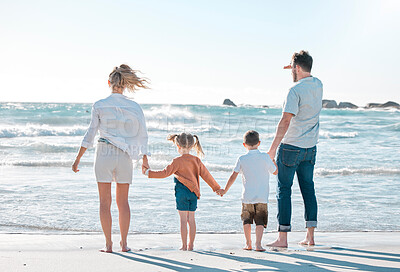 Buy stock photo Travel, parents and kids holding hands on beach for holiday adventure together in tropical island waves. Mother, father and children on ocean vacation with support, relax and family bonding from back