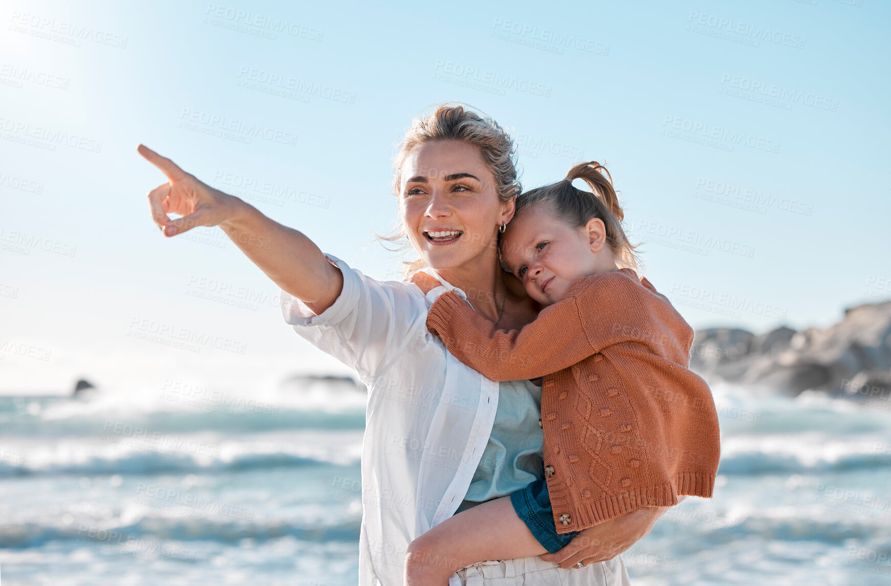 Buy stock photo Pointing, mom and kid on beach for holiday adventure together on tropical island with blue sky. Nature, mother and girl child on ocean vacation with travel, support and happy bonding in Australia