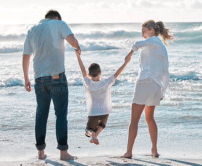 Buy stock photo Parents, kid and holding hands with playing on beach for bonding, holiday and summer vacation. Back view, couple and child on sand at ocean for getaway trip, travel and scenery with love and care