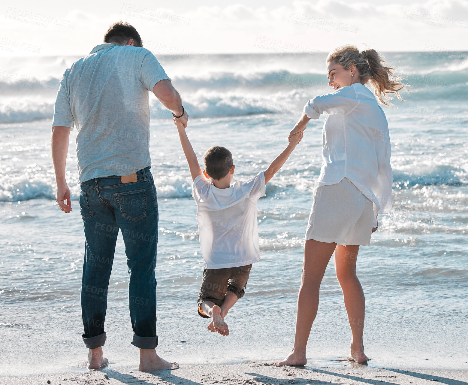 Buy stock photo Parents, kid and holding hands with playing on beach for bonding, holiday and summer vacation. Back view, couple and child on sand at ocean for getaway trip, travel and scenery with love and care