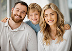 Portrait of happy parents and their little son at home. Adorable caucasian boy smiling with an arm around his mother and father. Young parents enjoying free time with their son on weekend