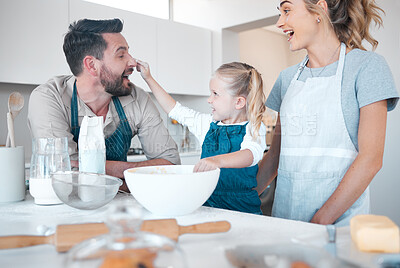 Buy stock photo Kitchen, baking and playful family with girl, cooking and happy with help prepare milk, flour or food. Parents, love and home fun with mother, father and bonding for child with support at house