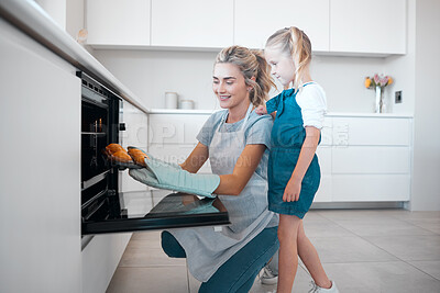 Buy stock photo Mom, oven and daughter in kitchen, baking and teaching of child to cook, recipe and muffins in home. Happy, girl and woman with gloves, smile and family with dessert, cupcakes and love for food