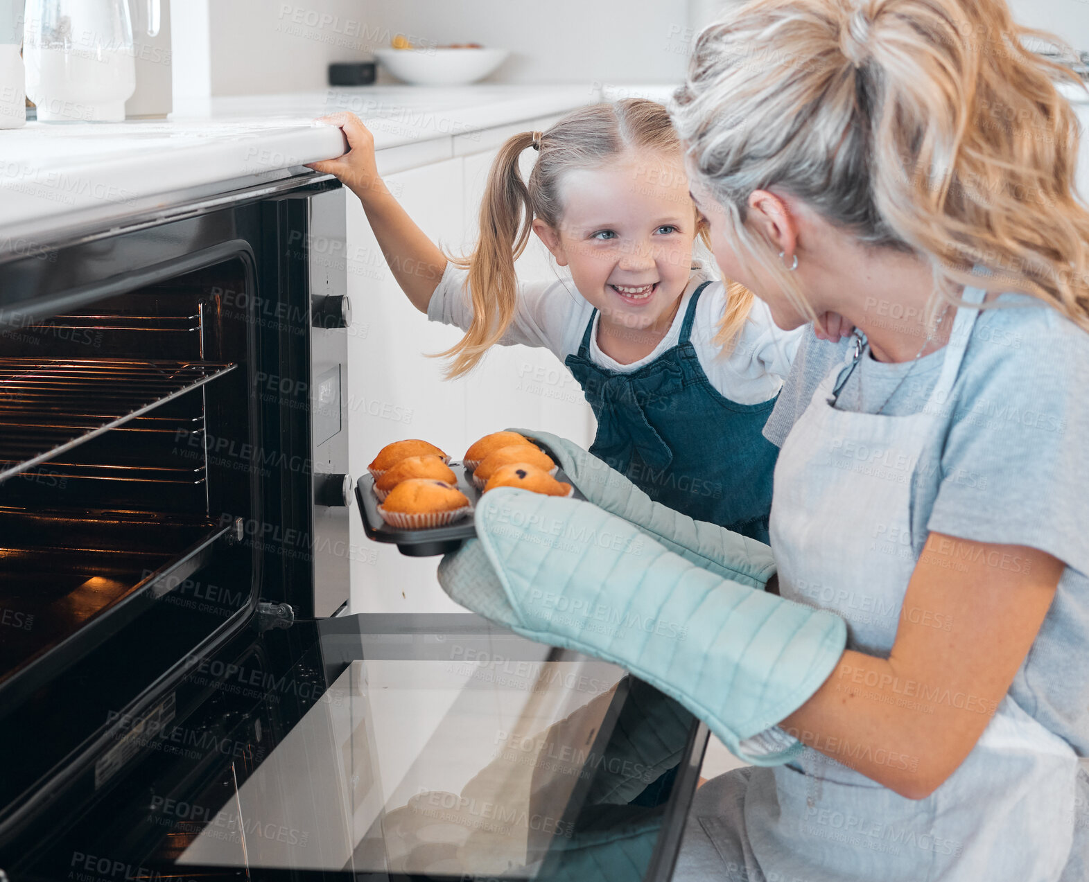 Buy stock photo Mom, girl and kitchen with cooking muffins for hungry family or healthy diet, safety or nutrition with care. Mother, daughter and baking together in home with help for desert, learning or development