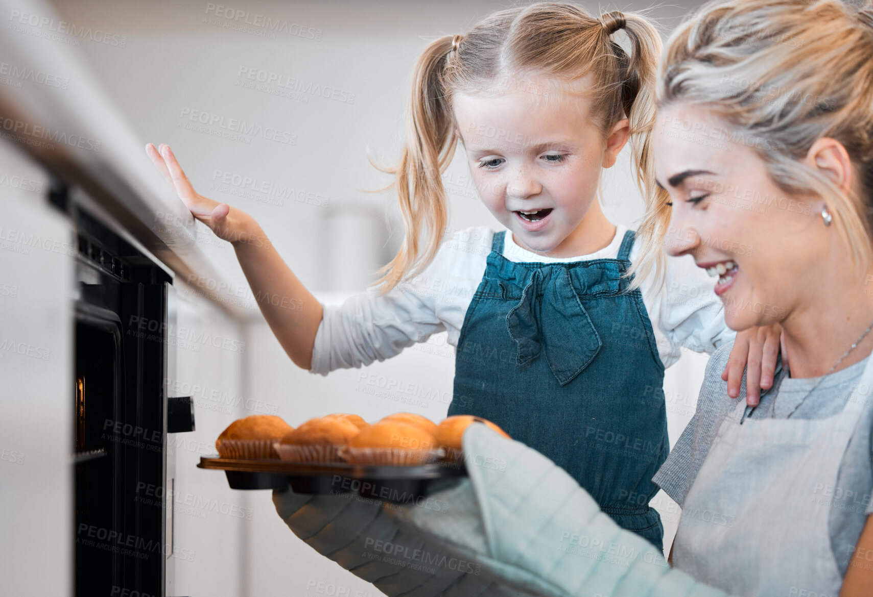 Buy stock photo Kitchen, baking and muffins with excited daughter cooking, happy and mother with tray, cupcakes or sweet food. Mama, love and family home fun or woman bonding with child development, support and care