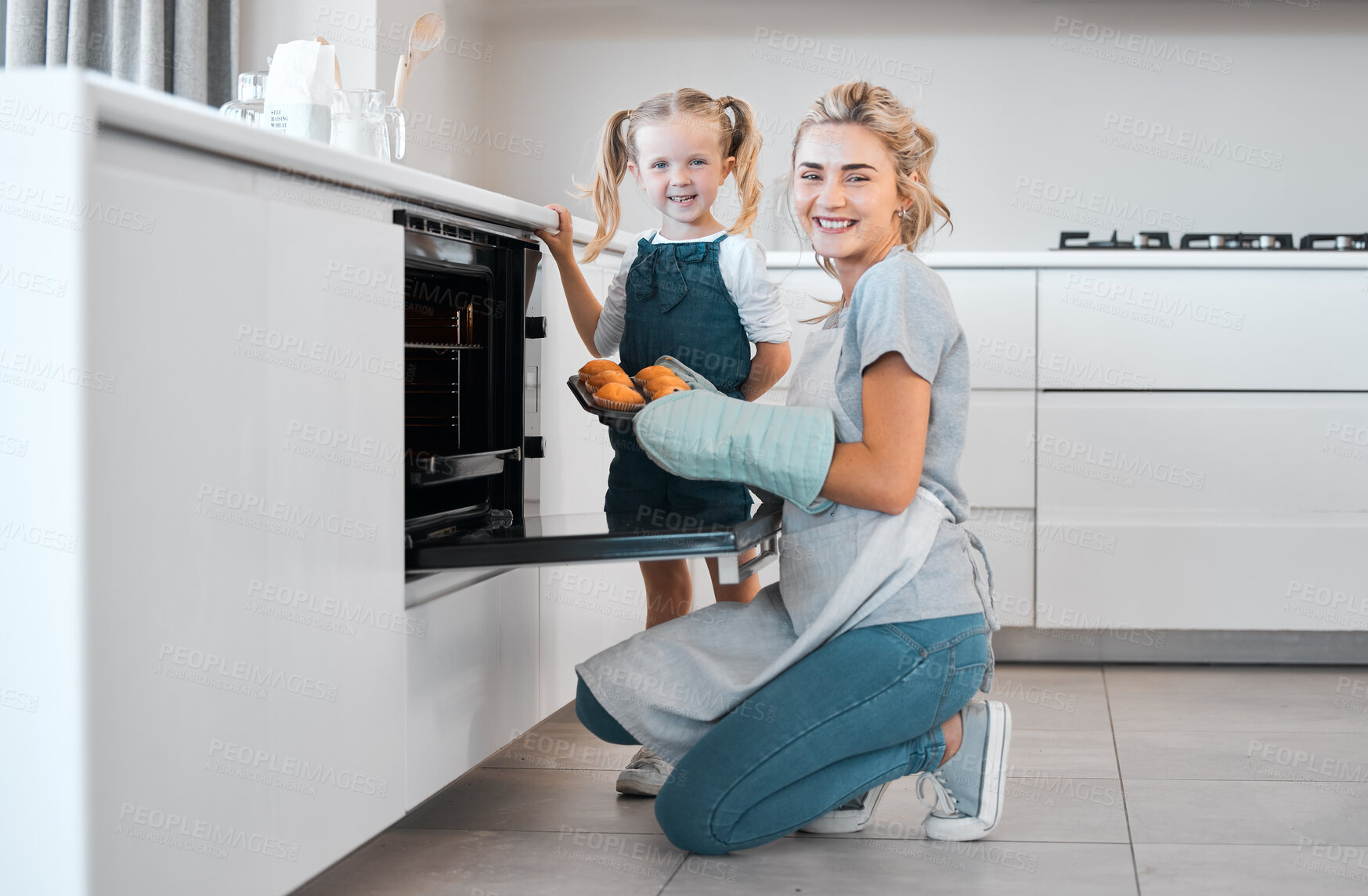 Buy stock photo Kitchen baking, mother and daughter portrait cooking, happy and tray for muffins, cupcakes or sweet food. Mama, love and family fun or woman bonding with kid, child development support and home