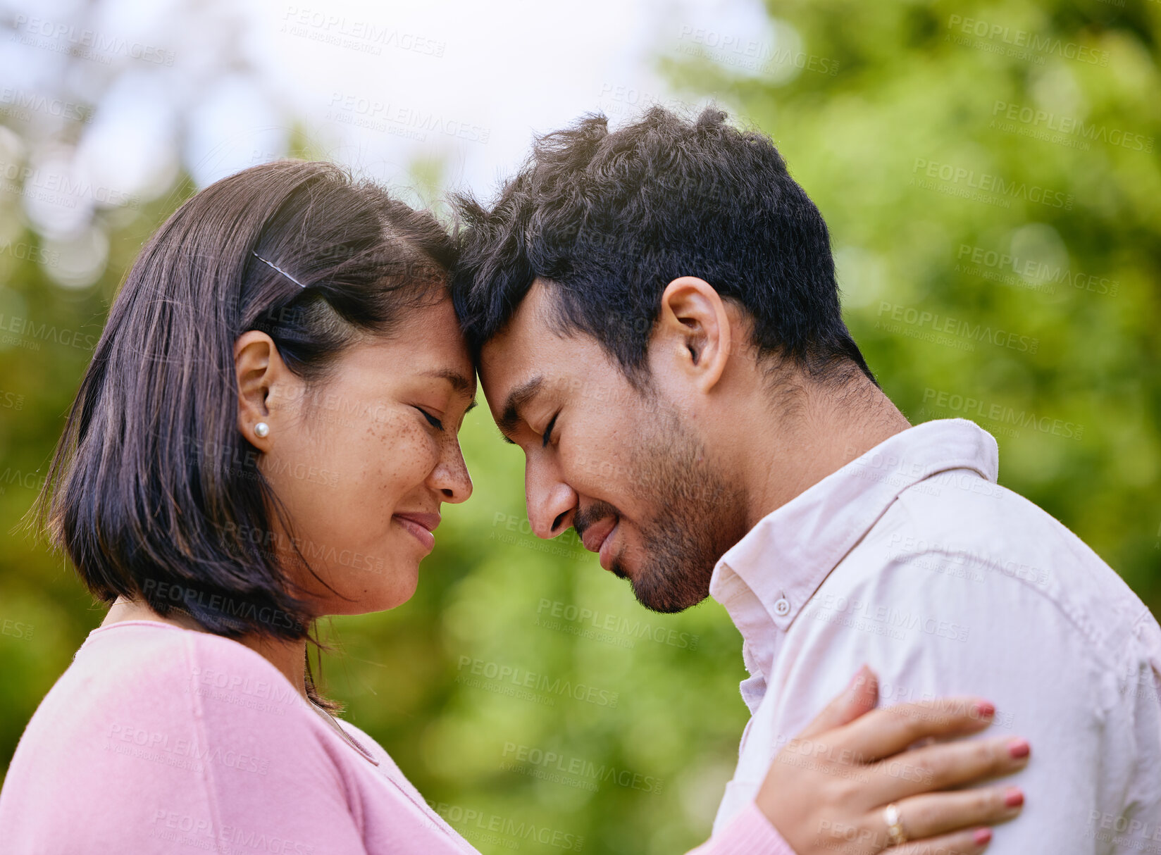 Buy stock photo Couple, eyes closed and forehead or happy in nature, smile and commitment together for relationship bonding. Love, romance and married people in park, trust and support with partners for intimacy