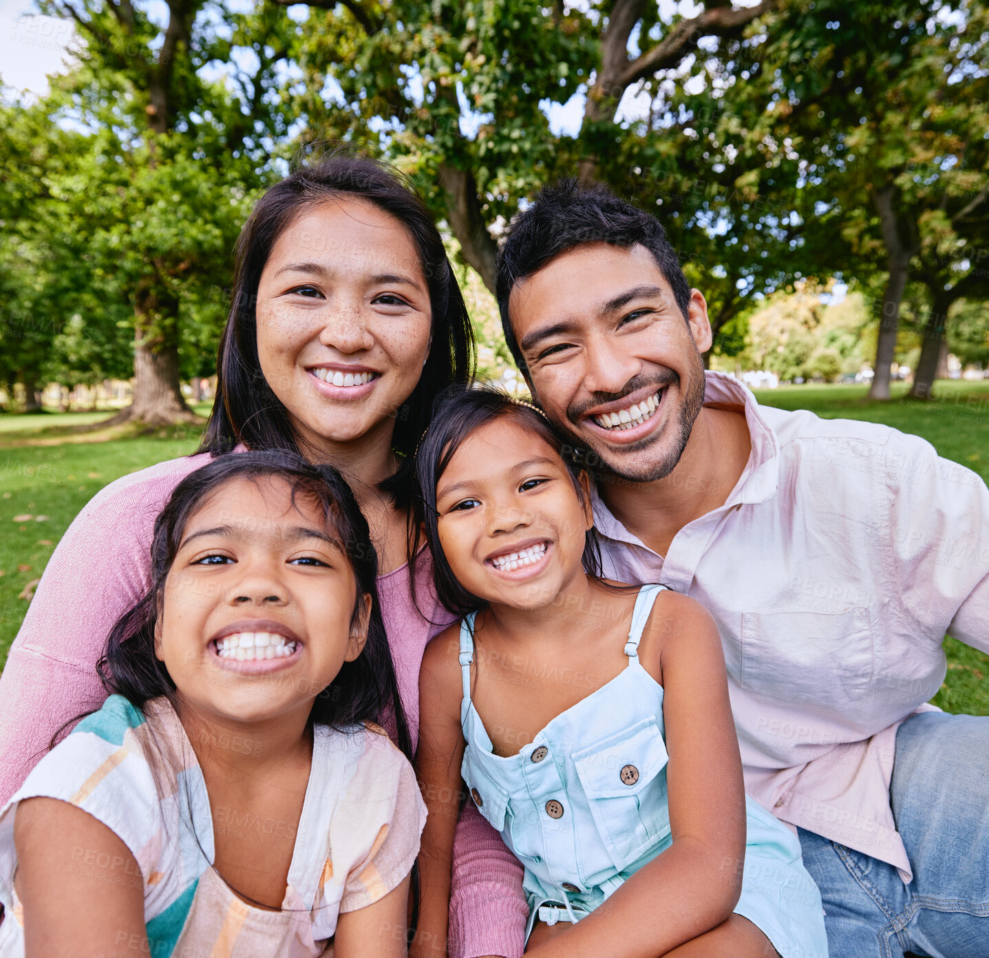 Buy stock photo Family, park and portrait with happiness for wellness or bonding, together in nature with support. Mixed race people, children and parents on grass for vacation in Europe, smile for travel with kids