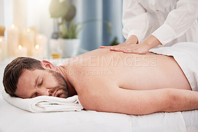 Buy stock photo Back, massage and man at spa to relax with therapist,  wellness and luxury holistic treatment on table. Self care, masseuse and client on bed for body health, muscle care and peace with hotel service