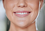 Closeup of unknown smiling woman alone in gym. Happy headshot caucasian trainer showing clean teeth while standing after routine workout in health club. Coach in fitness centre for exercise training