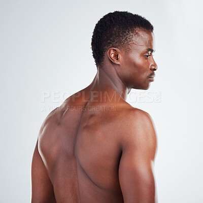 Buy stock photo Black man, shirtless and back with muscle in studio for health, bodybuilding and pride on white background. Thinking, serious athlete and bodybuilder with confidence for fitness, glow and wellness