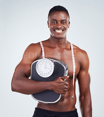 Buy stock photo Measuring tape, happy and portrait of man with scale in studio for bulking progress with body building. Smile, fitness and African person with weight or bmi tracking tools for gym by white background