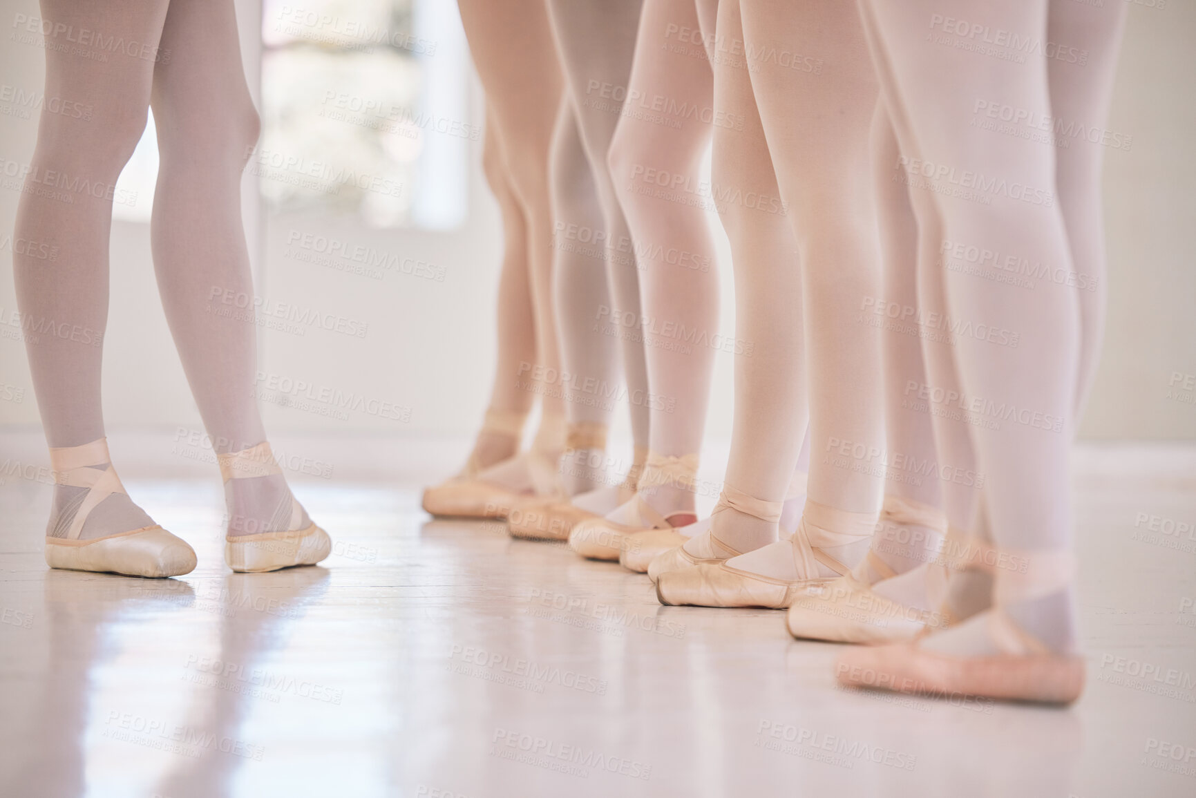 Buy stock photo Feet, ballet and dance class with studio teacher and student group for performance and training. Ballerina, teaching and legs with routine learning and practice with toe shoes of dancer in line