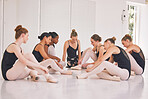 Young woman dance instructor teaching a ballet class to a group of a children in her studio. Ballerina teacher working with girl students, preparing for their recital, performance or upcoming show