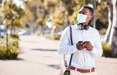 Buy stock photo Black man, phone and face mask in outdoor for social media, pandemic and online for conversation. Male person, employee and travel in city for commute, app and email business contact on sidewalk