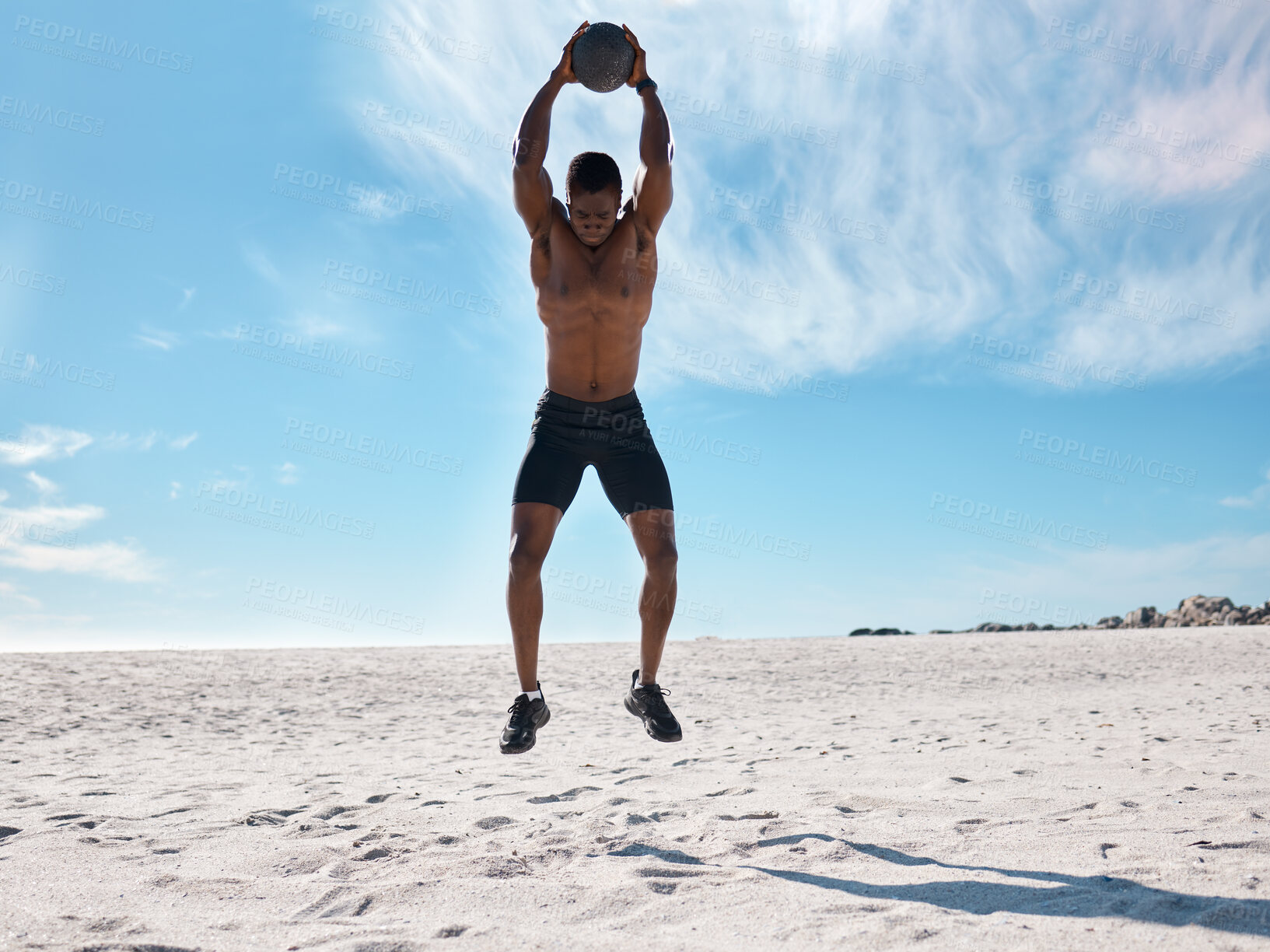 Buy stock photo Fitness, black man and jump with medicine ball for exercise, energy and healthy body at beach. Training, equipment and athlete workout for power, strong muscle and wellness outdoor with bodybuilder