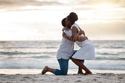 Buy stock photo Couple, engagement and sunset at beach for holiday, travel and date in summer while bonding together. Man, woman and marriage proposal by ocean for vacation, love and romance with hug, water and sand