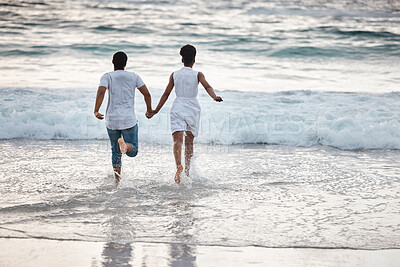 Buy stock photo Running, black couple and water with vacation, holding hands or celebrating for anniversary. Back view, splash and people travel for marriage on honeymoon, summer holiday and happy bonding in Miami