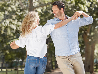 Buy stock photo Happy, couple and dancing with love outdoor for relationship romance, marriage anniversary and bonding in sunshine. Woman, man and affection with care, holding hands and commitment in garden for date