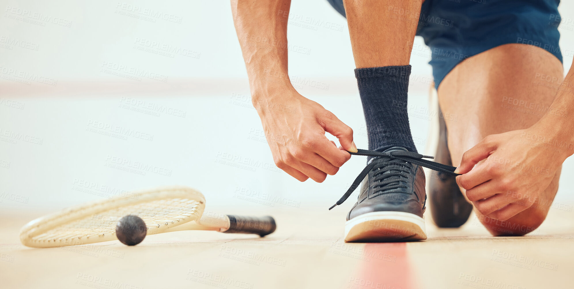 Buy stock photo Feet, athlete and shoes in court, tying and determination for playing in sports, training and practice. Fitness, sportsman and kneeling for tournament, squash player or routine of exercise for person